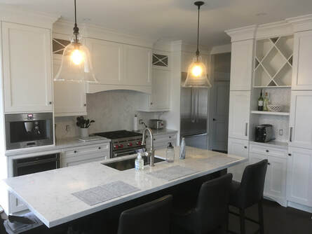 Contemporary kitchen - herringbone tile, white cupboards, white granite countertops.