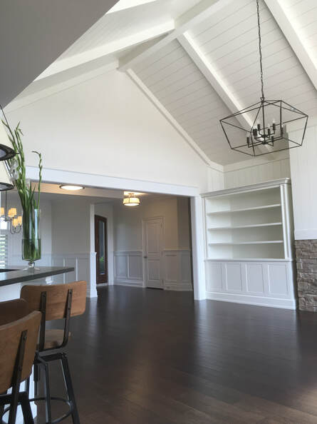 Shiplap ceiling and wainscotting in a large, upscale great room.